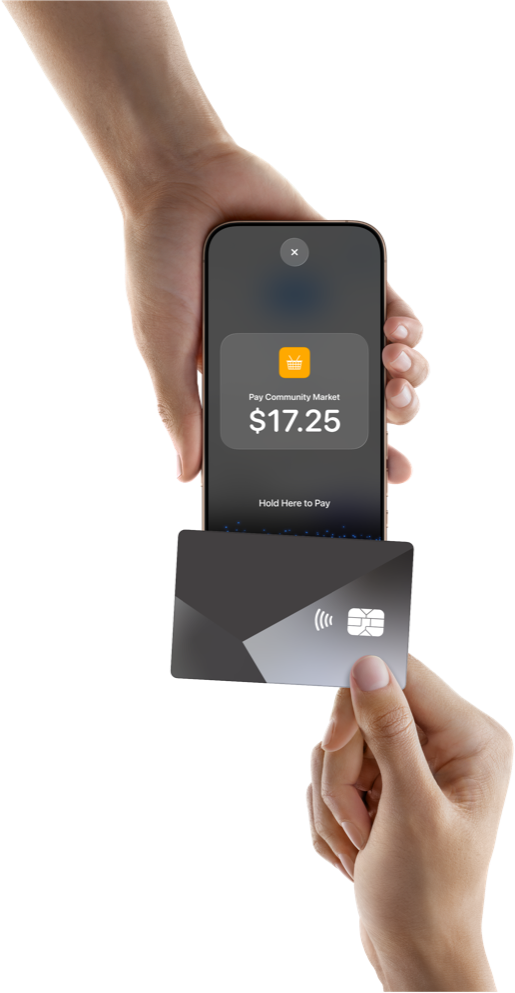 A customer taps a contactless card on an iPhone held by a merchant.